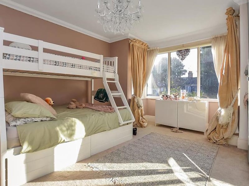 The second bedroom is also a good size, with a double-glazed window to the back of the property. There is a fireplace, which can be restored if the wardrobes are moved.