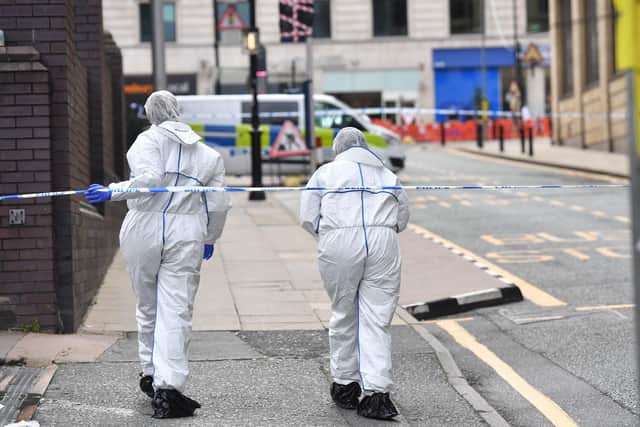 Two police forensics officers enter the cordoned area in Livery Street in Birmingham after one person was killed and seven injured in the city centre
Picture: Jacob King/PA Wire