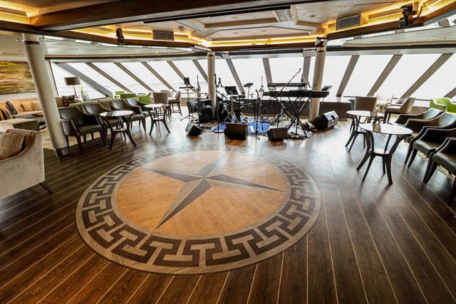 Explore the inside of Star Legend, a luxurious cruise ship operated by Windstar Cruises. Pictured - The Compass Lounge