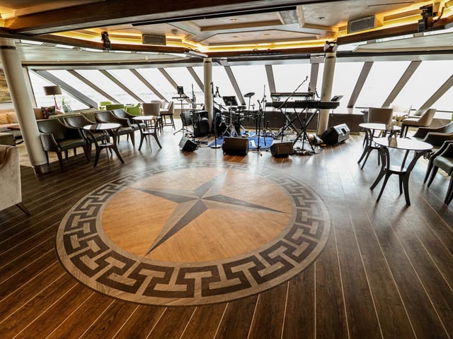 Explore the inside of Star Legend, a luxurious cruise ship operated by Windstar Cruises. Pictured - The Compass Lounge