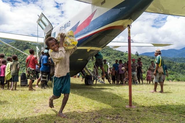 Pilots had to traverse constantly changing climate to deliver the nets. An MAF aircraft at the Wanakipa Airstrip. Picture: LuAnne Cadd/MAF.