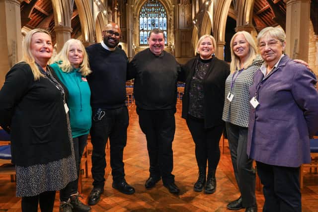 The handing out of collections for Comfort and Joy 2023 at St Mary's Church, Fratton. The Venerable Bob White, centre, with (from left) Sherry Craig of Two Saints, Michelle Treacher of Hope into Action, Rev Rajiv Sidhu, Claire Lambon of Stop Domestic Abuse, Mel Goddard and Carole Damper of Roberts Centre, . Picture: Chris Moorhouse