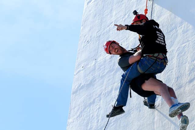 Jack Farrugia in a teandem abseil down the Spinnaker Tower, Portsmouth, in aid of his friend Josh Henwood-Evans. Picture: Chris Moorhouse (jpns 140522-35)