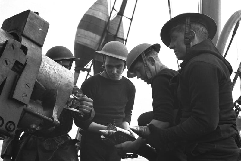 Crew members loading the gun on a Royal Navy minesweeper during World War II, March 1941.  (Photo by Horace Abrahams/Keystone Features/Hulton Archive/Getty Images)