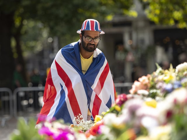 Onlooker admires flowers at the square.