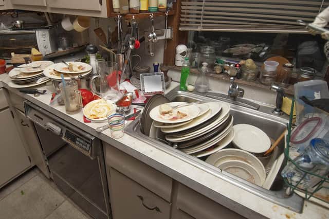 A huge pile of dirty dishes in the sink. Picture by Shutterstock