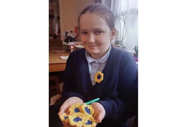Amelia Smith with some of her flower pins.