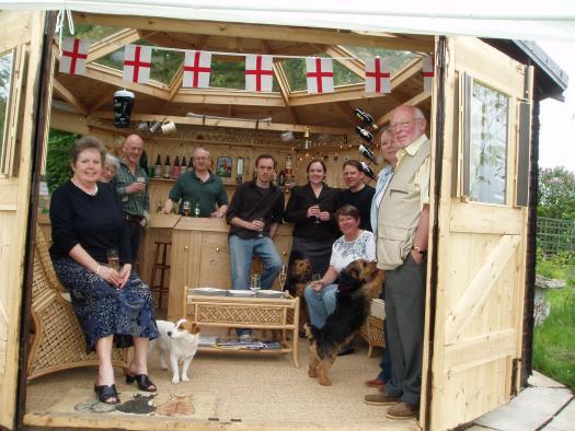 Ah, remember when you could invite people over to your garden. The Rugby Pub won the competition in 2008
Designed and built by owner Tim ,with eight roof lights in octagonal roof, pair of double doors opening as one entrance in fine weather, 15' fully fitted bar with additional door behind and storage under including 3 fridges, blinds to windows and roof lights, ceiling fan, sink with cold running water, comfortably furnished with sea grass matting floor, Hammock. No phone, no TV ,no interruptions ,no shortage of liquid refreshment, no inclination to go any where else and no need to.