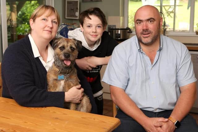 Delighted Samuel Brotherton, 13, pictured with his dog Melchy less than a day after two men pushed him to the ground and stole the dog in Horndean. Samuel is pictured with mum Donna and dad Mark at their home. Picture: Habibur Rahman