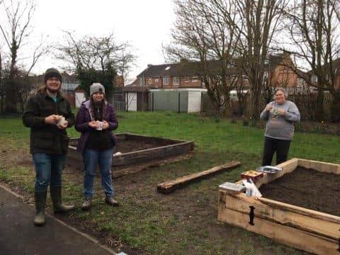 Volunteers and staff members (l to r) Kerster Hull, Phoebie Hull and Suzi Hoskins take a break for work on the allotment.