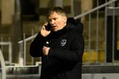 Joe Gallen on the phone to Kenny Jackett during last night's 3-1 defeat at Bristol Rovers. Picture: Graham Hunt/ProSportsImages