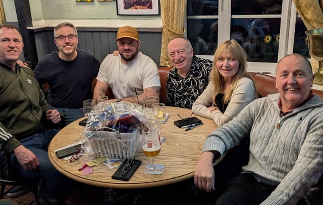 Gary Parker with the winning quiz team, Ronnie's Revamped