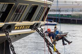 Firefighters practicing rescue from the sea, ascending by rope onto HMS Warrior during the UKRO event at Portsmouth Historic Dockyard. Picture: Mike Cooter (280924)