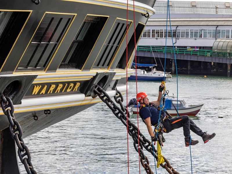 Firefighters practicing rescue from the sea, ascending by rope onto HMS Warrior during the UKRO event at Portsmouth Historic Dockyard. Picture: Mike Cooter (280924)