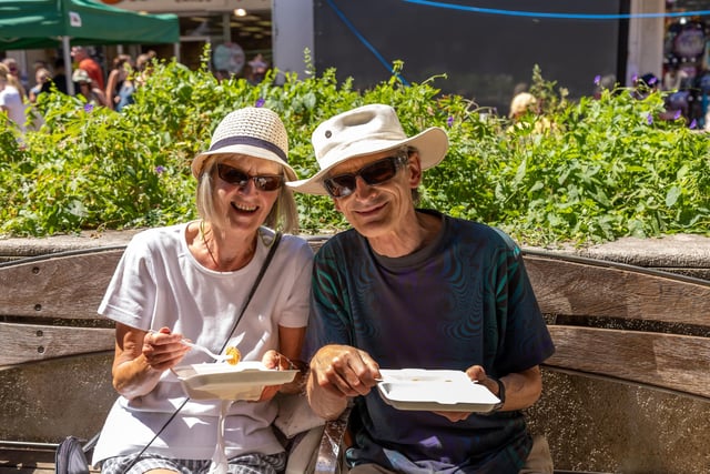 Susan Hudson (76) and Jim Warren (76) enjoy some Sicilian arancini at the Southsea Food Festival.  Picture: Mike Cooter (160722)
