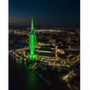 The tower all lit up in green - though it will not be repainted as part of the partnership