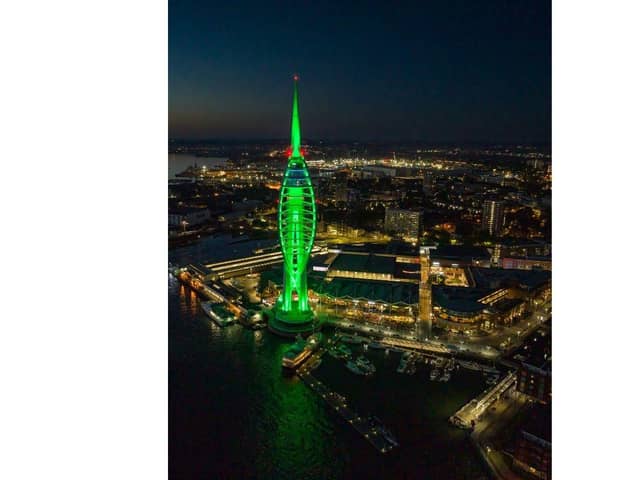 The tower all lit up in green - though it will not be repainted as part of the partnership