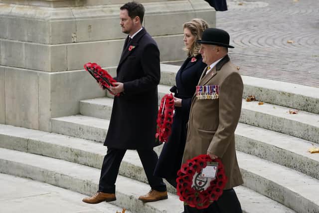 Portsmouth North MP Penny Mordaunt (centre) and Portsmouth South MP Stephen Morgan (left) lay wreaths at the WWI memorial during the Remembrance Service at the Guildhall Square, in Portsmouth. Picture date: Sunday November 14, 2021.