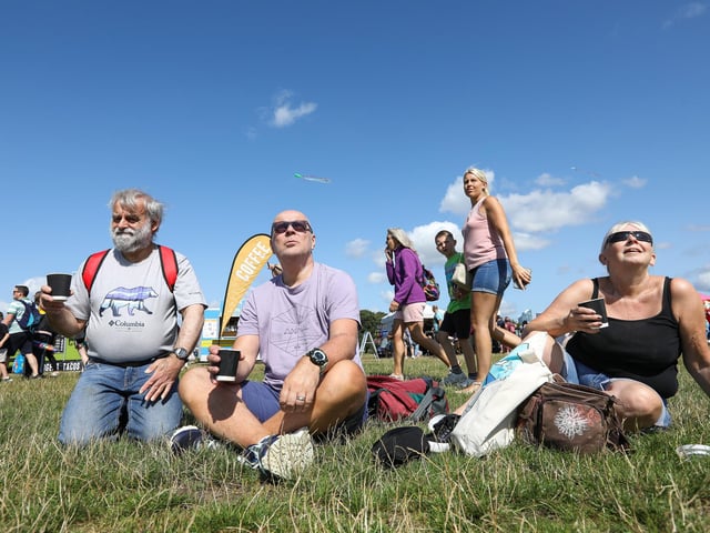 Patrick Ford, Andy and Terri Bell enjoy a coffee as they watch the procession of kites.Picture: Chris Moorhouse (270724-15)