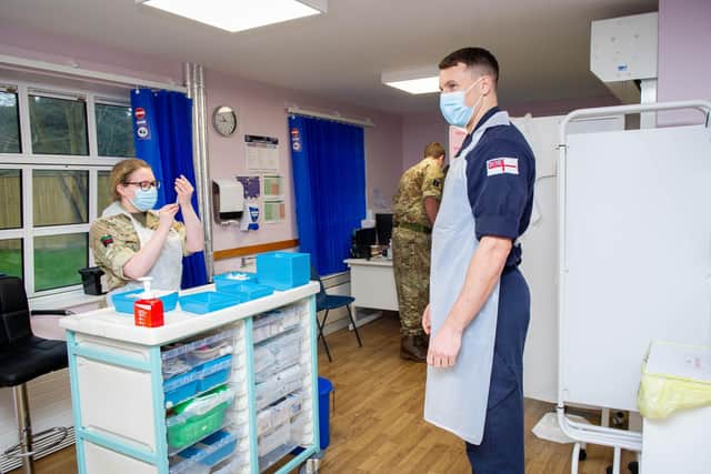 Kate Blyth from the Army preparing a dose of the booster with POPT Tom Monday from the Royal Navy 
Picture: Habibur Rahman