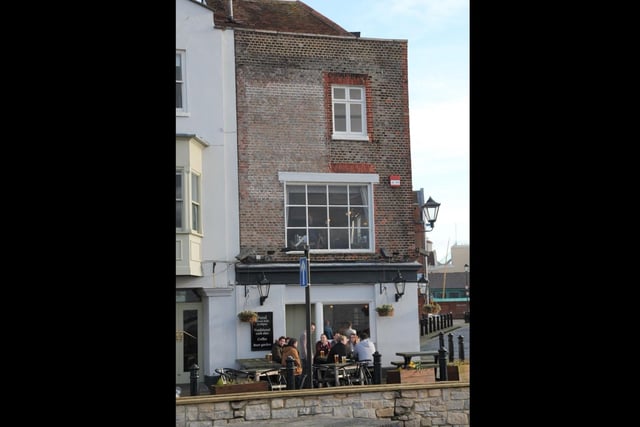 Another view of the faded sign at the top-right of popular Old Portsmouth pub, Spice Island.
