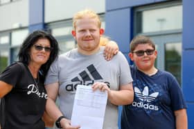 Reece Myatt, centre, with his mother Tina and his brother Marley. Reece has achieved Distinction*, Distinction and Merits and is going to read Earth Sciences at the University of Portsmouth. 
Picture: Chris Moorhouse (jpns 170823-20)