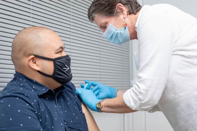Booster vaccines being given at Goldchem Pharmacy, Albert Rd, Portsmouth on Wednesday 15th December 2021. Registered nurse,Kate Finch giving a booster jab to Adrian Ulanimo. Picture: Habibur Rahman