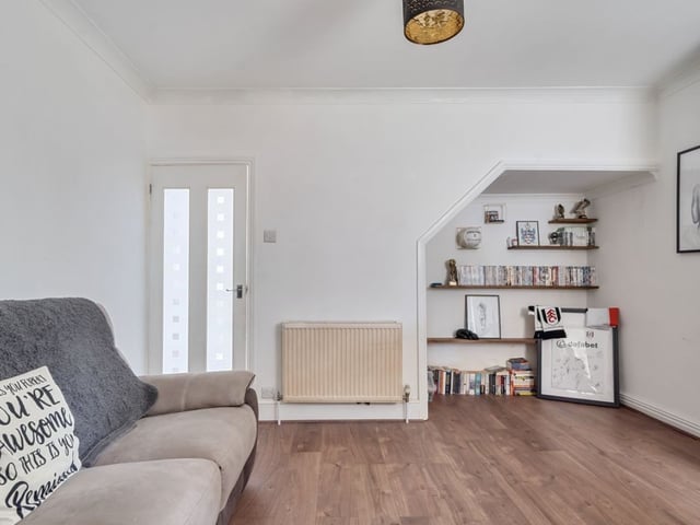The living room area is a light and spacious area that has plenty of space for a large sofa and chairs.