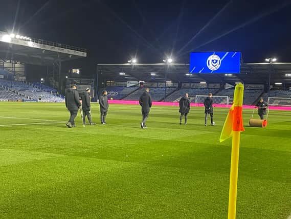 Referee Sam Purkiss inspects the pitch at Fratton Park this evening