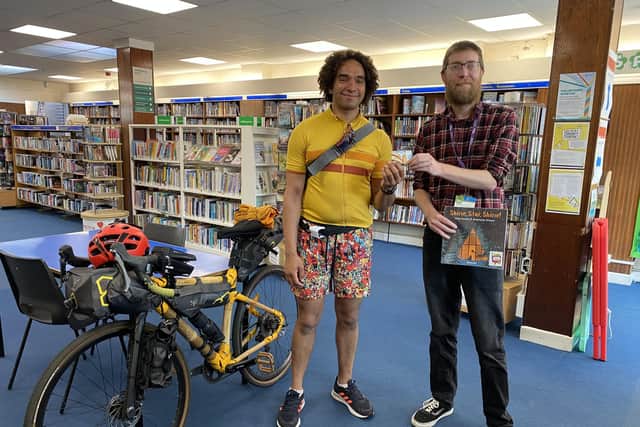 Joseph Coelho gets his library card from North End Library supervisor Grant Nelson