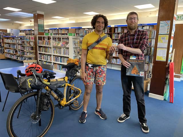 Joseph Coelho gets his library card from North End Library supervisor Grant Nelson