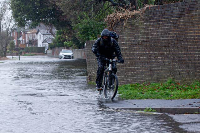 Cyclist riding through the flood around Wallington, Fareham on Tuesday 7th December 2021. Picture: Habibur Rahman