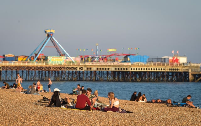 People soak up the evening sun on Southsea Beach on September 21, 2020 in Portsmouth, England.  (Photo by Finnbarr Webster / Getty Images)