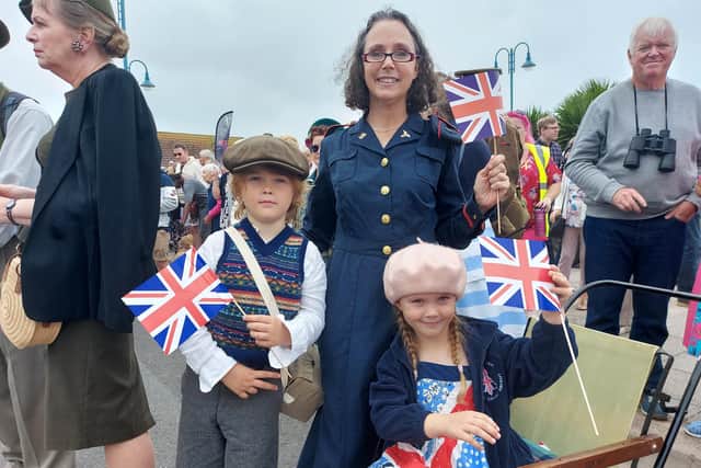 Pamela Lechie, 48, from Berkshire with her children Glen, seven, and Heather, six, at the Lee Victory Festival parade on September 25, 2021