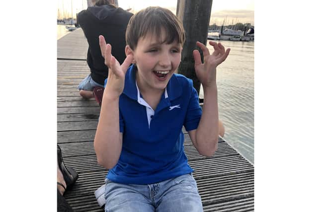 Stephanie Carpenter caught a large bass while out crabbing with her partner Andy Wilkinson and son Joseph Carpenter, 11. Pictured: Joseph doing the Makaton sign for crab