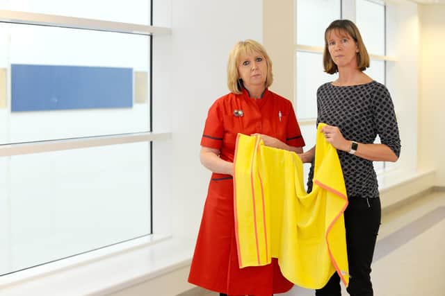 Inspector Louise Tester, right, with Liz Rix, chief nurse at Portsmouth NHS Hospital Trust, pictured with a yellow towel similar to the one officers recovered from close to the scene, believed to have been used to wrap up the infant. 

Picture: Sarah Standing (300120-5162)