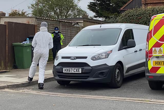 A forensic officer pictured heading towards the garden of the home Tunstall Road, Paulsgrove, where a man was stabbed multiple times. Photo: Tom Cotterill