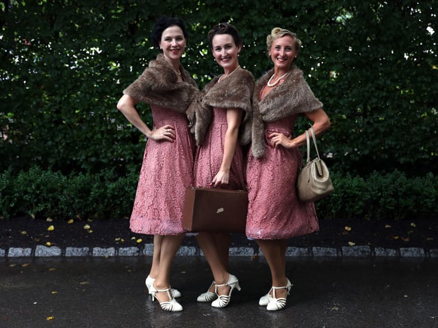 Spectators dressed in vintage clothing for Goodwood Revival 2024. Photo: Kieran Cleeves/PA Wire
