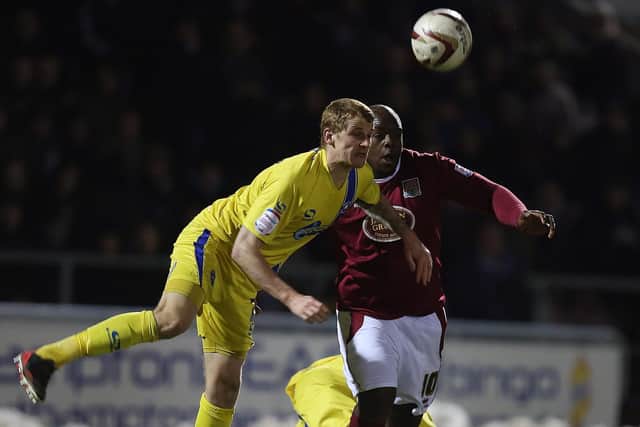 Joe Oastler, pictured playing for Torquay against Northampton's Adebayo Akinfenwa in March  2013. Photo by Pete Norton/Getty Images.