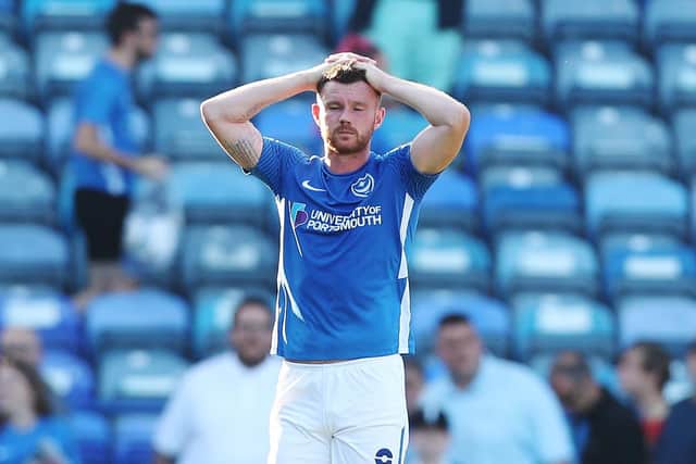 Pompey midfielder Ryan Tunnicliffe holds his head in his hands after Saturday's 1-0 defeat against Cambridge United.