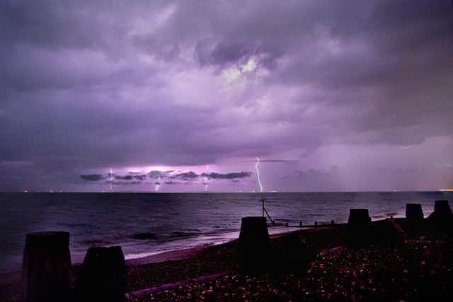 A yellow weather warning for thunderstorms has been forecast over Portsmouth on Sunday. Pictured are previous storms taken from Hayling Island Beach overlooking Portsmouth and the Isle of Wight. Picture: Adam Dawson/SWNS.