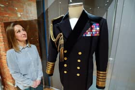 Kate Braun, curator at the National Museum of the Royal Navy, looks at a naval uniform which once belonged to the Duke of Edinburgh as it goes on display at the "Her Majesty's Service, The Queen's role at the heart of the Royal Navy family" exhibition at the National Museum Of The Royal Navy, Portsmouth Historic Dockyard. Picture: Andrew Matthews/PA Wire