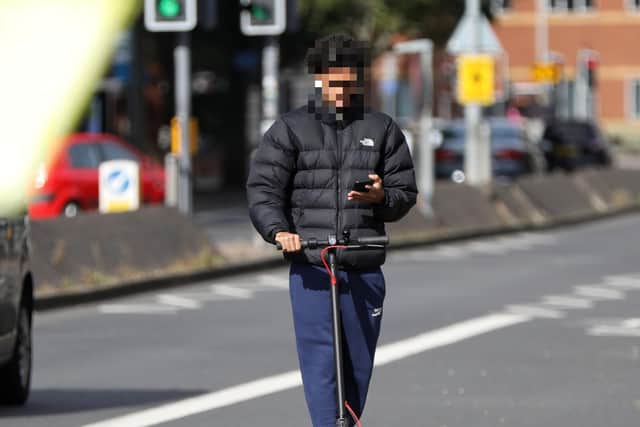 E-scooter rider on his phone in Winston Churchill Avenue, Portsmouth. Picture: Chris Moorhouse    (270820-07)