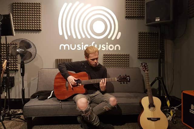 Music Fusion and The Spring in Havant have given young people the opportunity to develop as musicians with their 'music studio in a box' pilot. Pictured: Maison practising his guitar skills at the East Street Studio