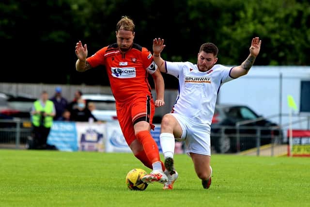 Bradley Lethbridge (white) tackles AFC Portchester's Sam Pearce at Privett Park. Picture: Tom Phillips