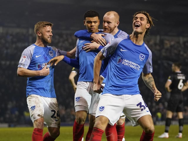 Dane Scarlett is congratulated by his team-mates following his late Pompey winner against Burton on Tuesday night