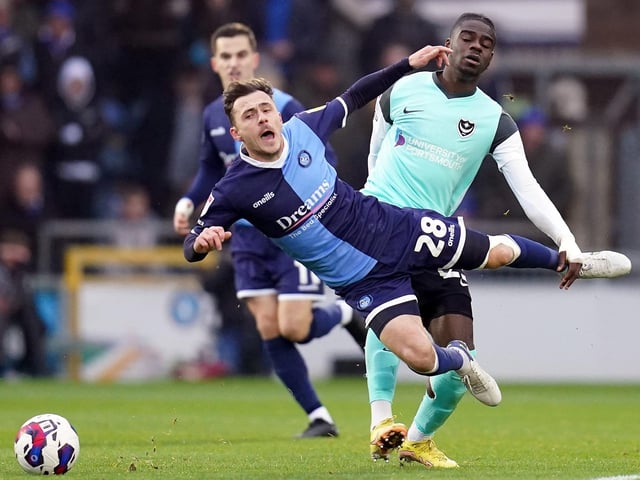 Josh Scowen is fouled by Jay Mingi during the first half of Pompey's clash with Wycombe. Picture: John Walton/PA Wire.
