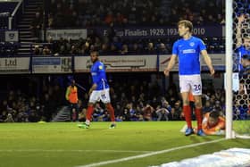 Pompey's players look to the linesman in vain following Chuks Aneke's offside in the build-up to Charlton's opener. Picture: Barry Zee