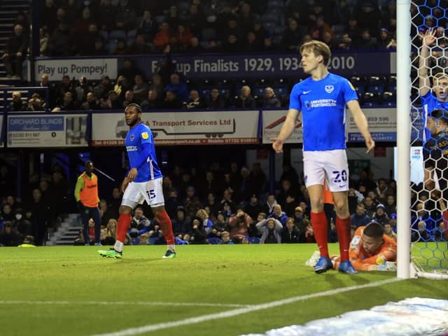 Pompey's players look to the linesman in vain following Chuks Aneke's offside in the build-up to Charlton's opener. Picture: Barry Zee