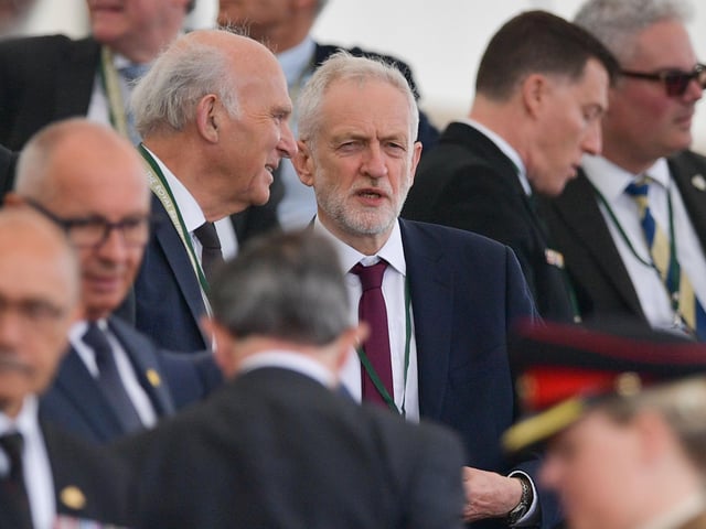 Jeremy Corbyn (R) speaks with Vince Cable (L)